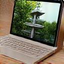 A digital tablet displaying a 3D garden render next to traditional Japanese gardening tools